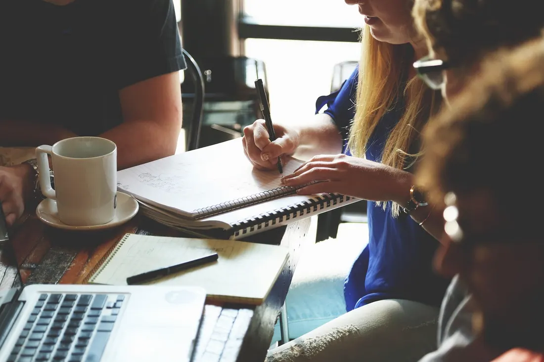 A small hiring team collaborating around a table
